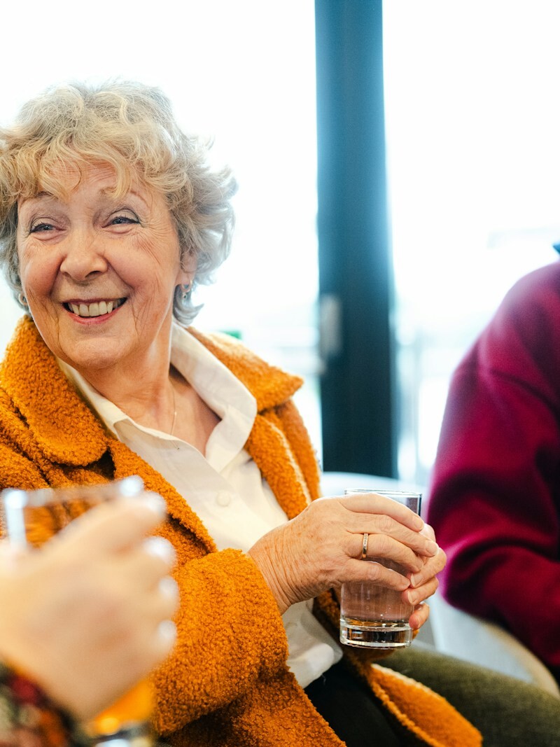 Three seniors talking and smiling together