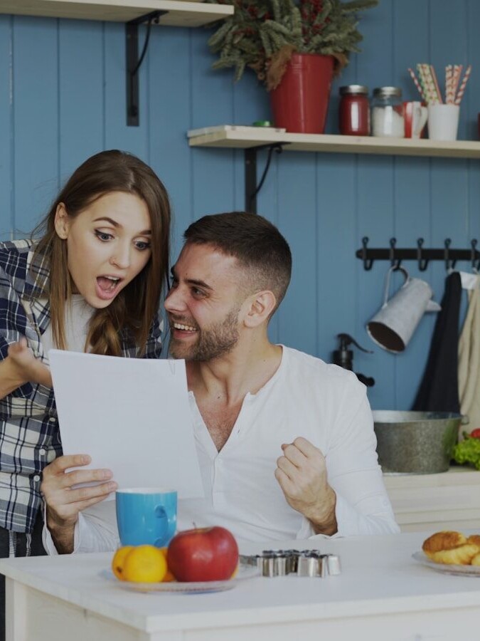 Couple reacting with excitement to a document