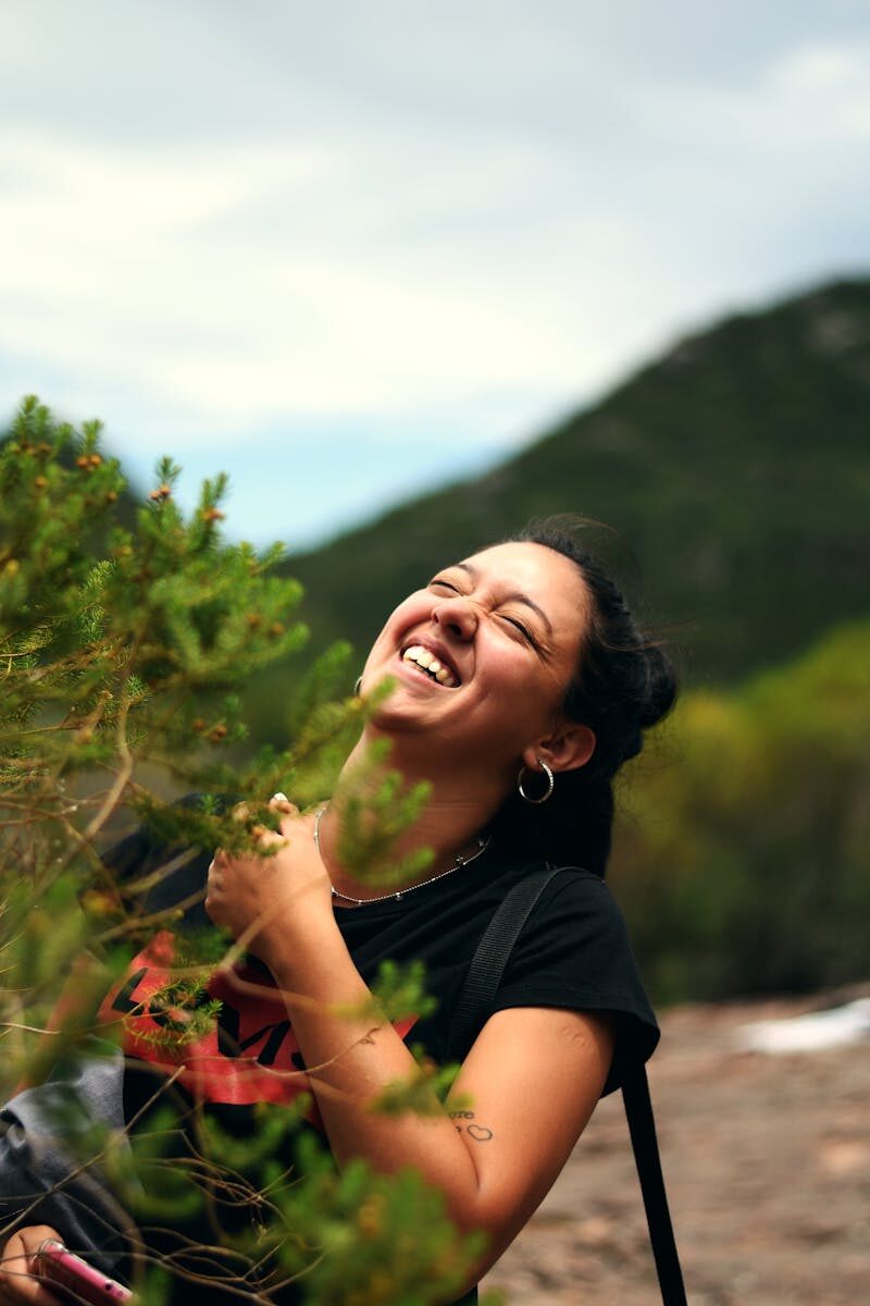 A woman laughs joyfully while hiking in Cerro Colorado, Cordoba, Argentina.